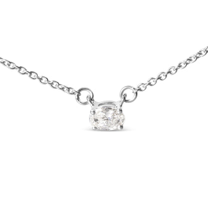 Close-up front view of a white metal necklace with an oval-shaped white gemstone in a four-prong setting.