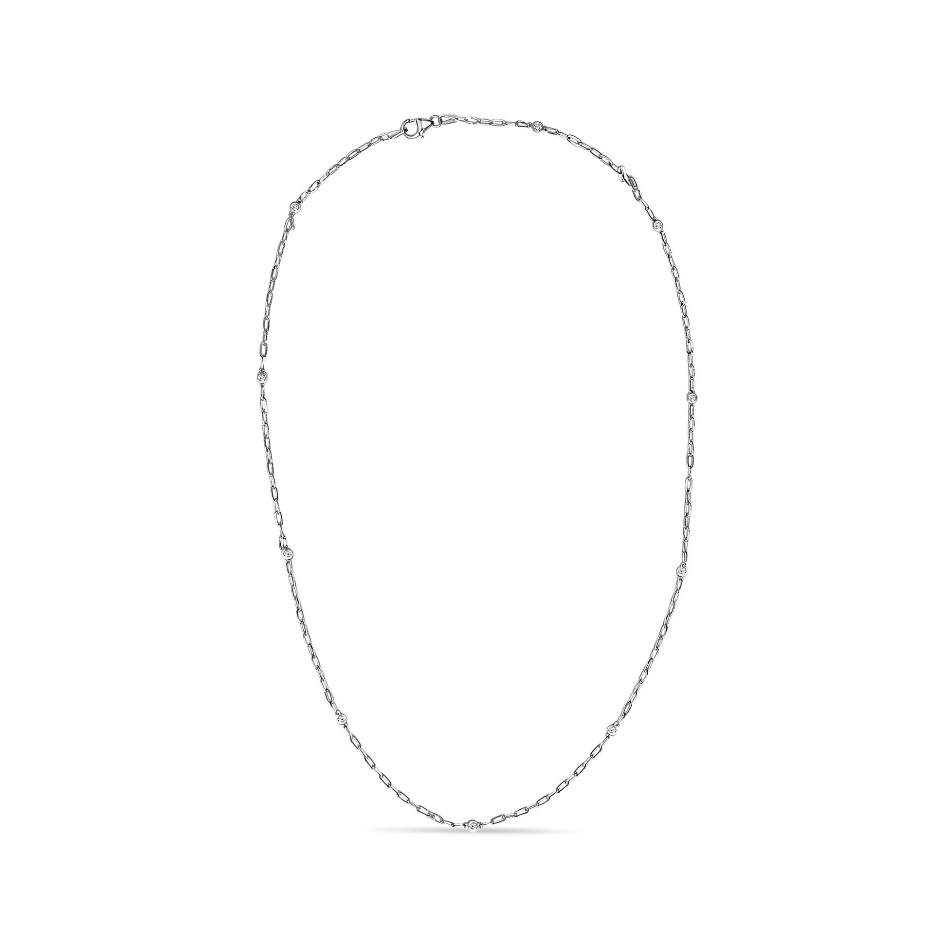 White metal necklace with a delicate link chain featuring round white gemstones in bezel settings evenly spaced, shown flat on a white background from a top-down angle.