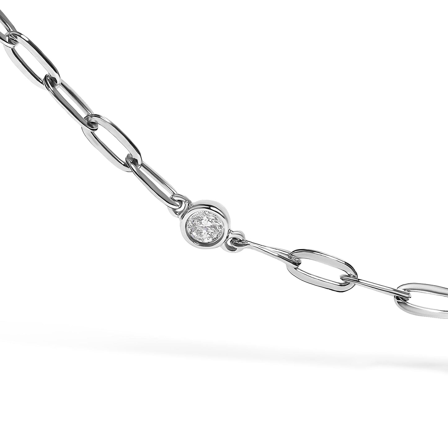 Close-up angled shot of a white metal necklace chain featuring a round white gemstone in bezel setting.