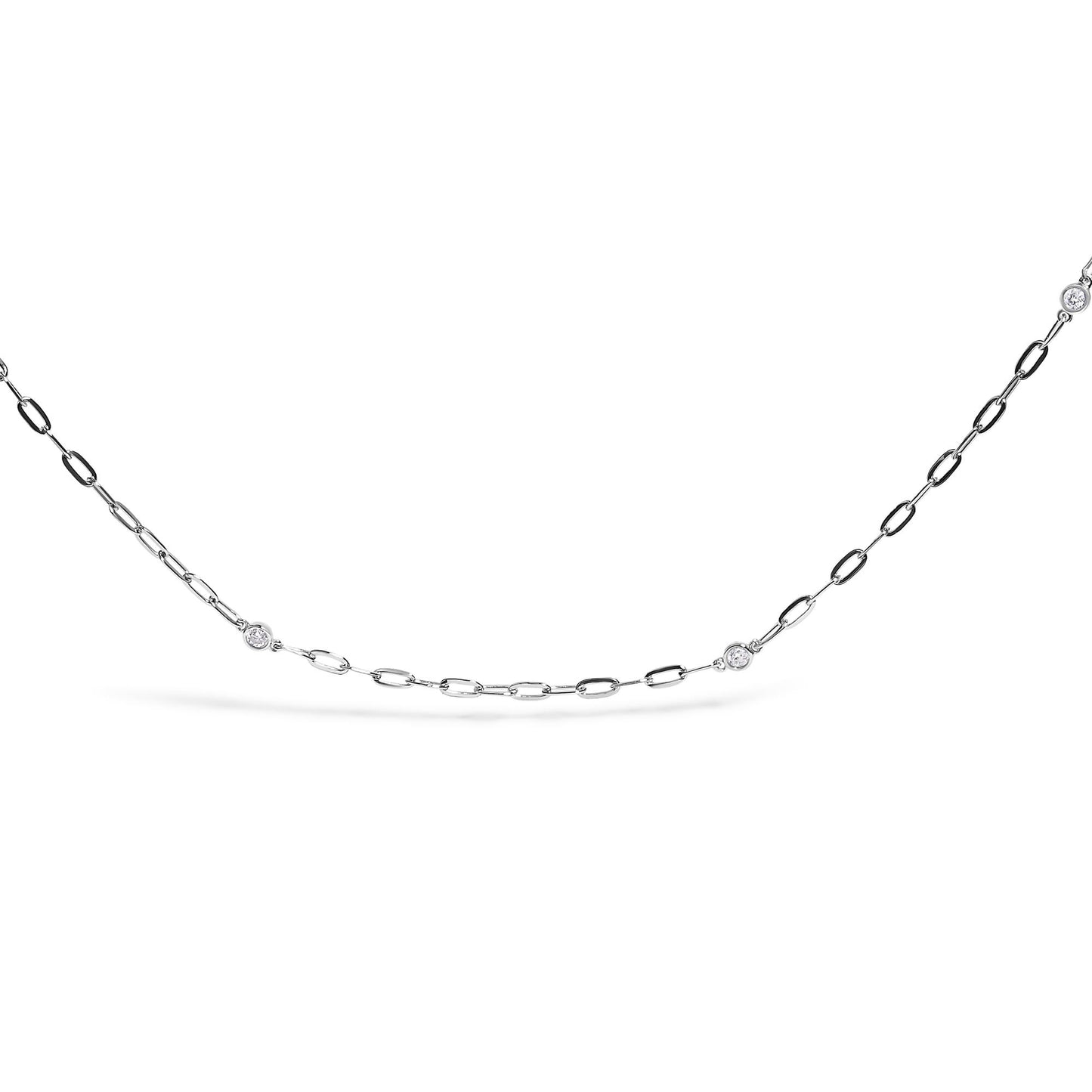 Close-up front angle of a white metal necklace featuring a chain with evenly spaced round white gemstones in bezel settings.