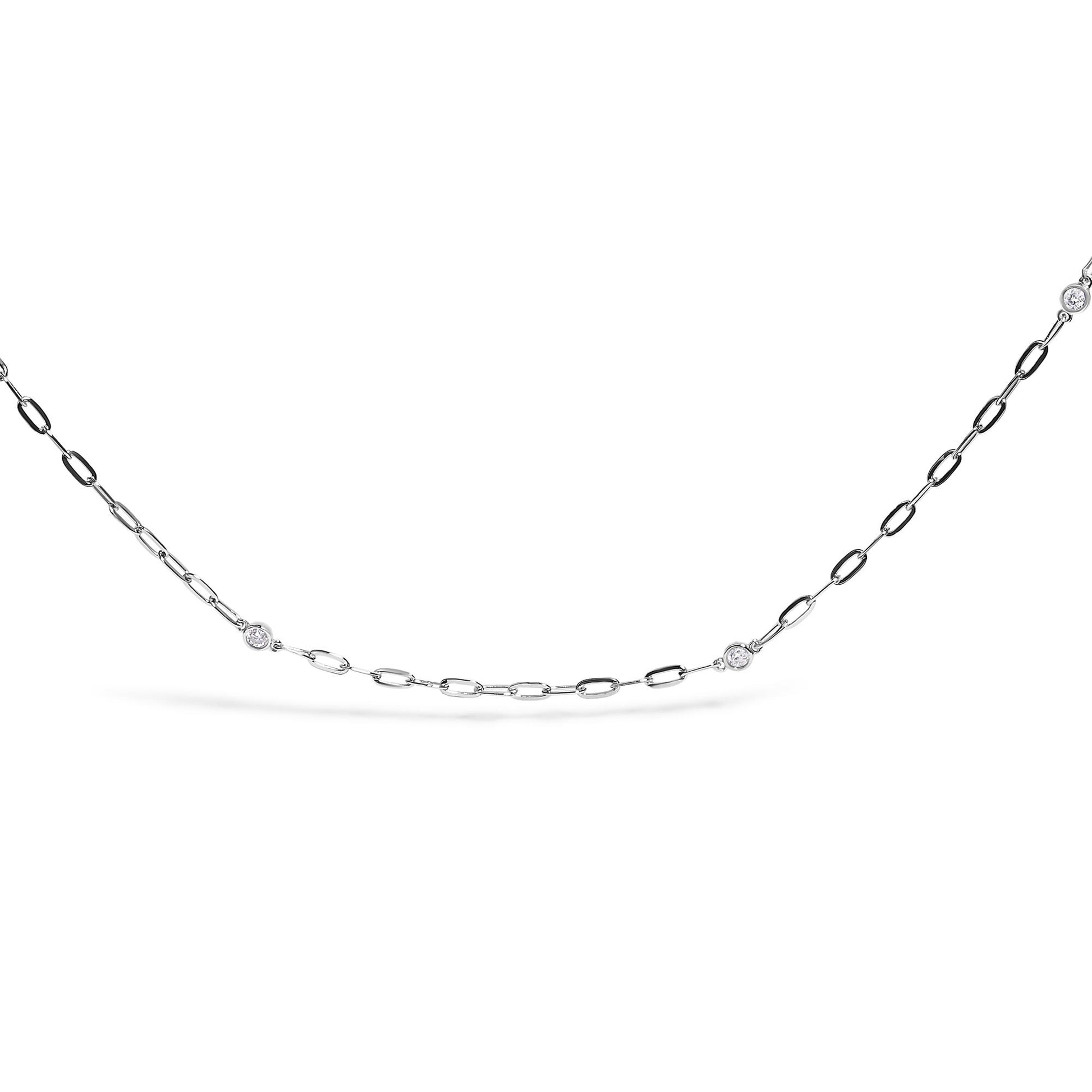 Close-up front angle of a white metal necklace featuring a chain with evenly spaced round white gemstones in bezel settings.