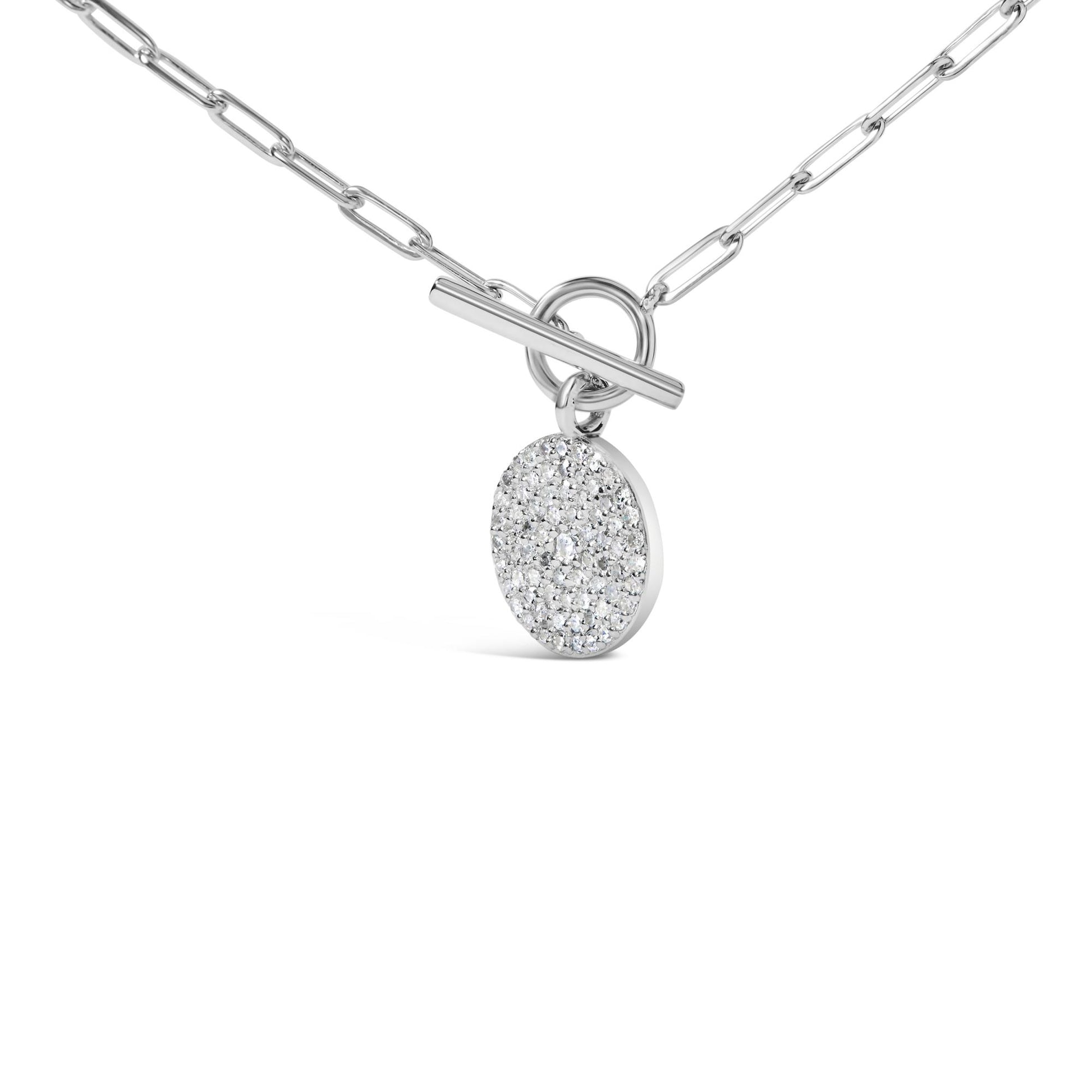 White metal necklace with a round pendant covered in small white gemstones and one larger white gemstone in the center, shown in a close-up angled front view.