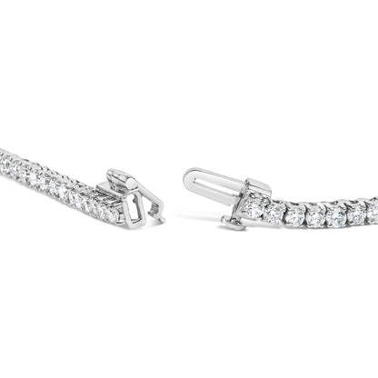 Close-up front angle of a white metal necklace with round white gemstones in 4-prong settings, showing the open clasp.