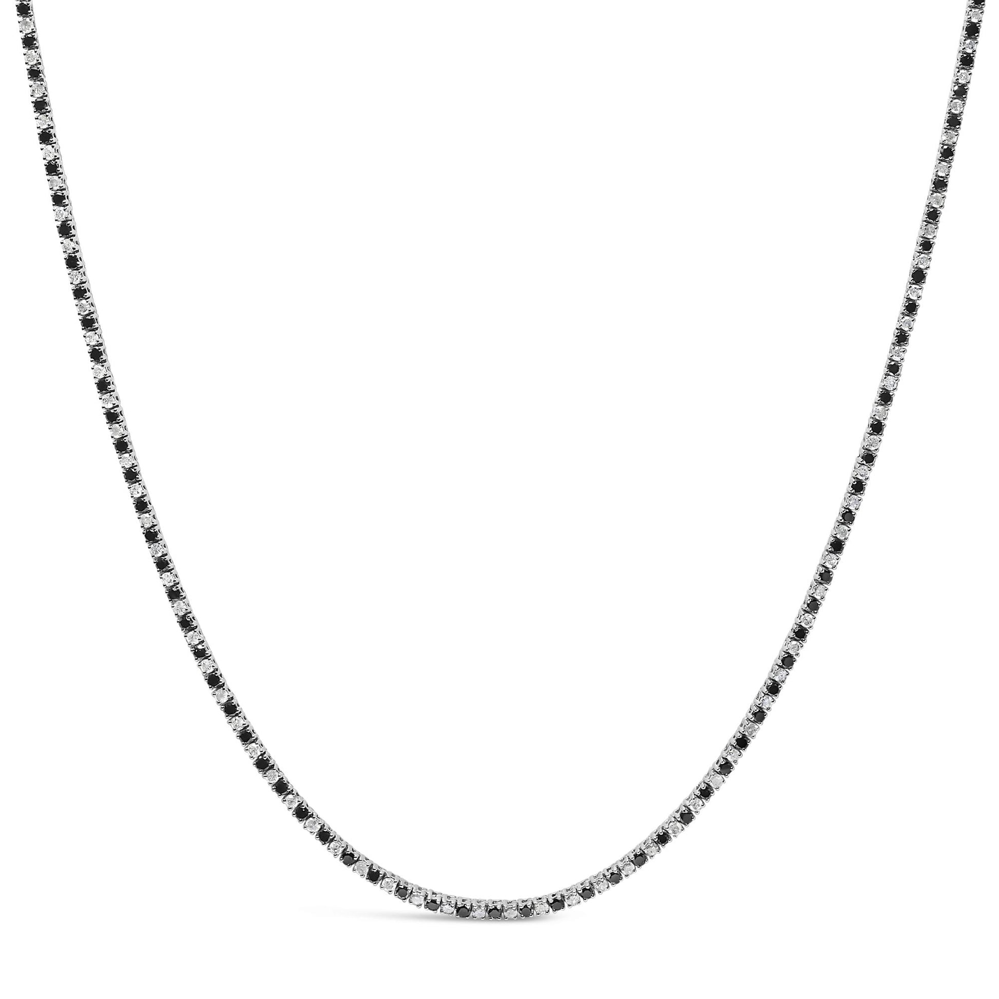 White metal necklace with alternating black and white round gemstones in 4-prong settings, shown against a white background from a front angle.