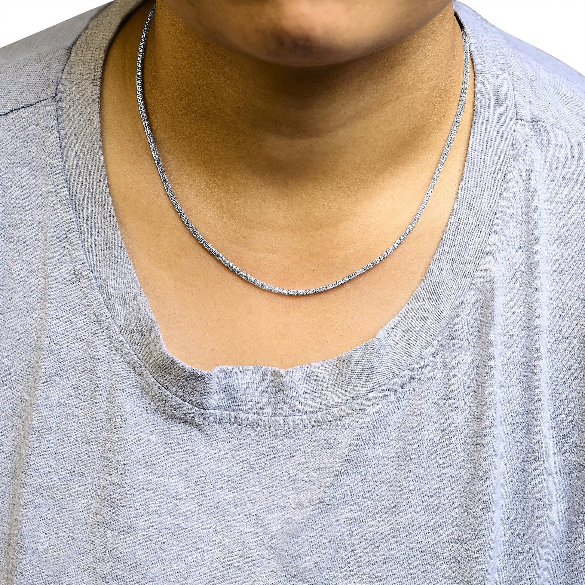 White metal necklace with two rows of round white gemstones in prong settings, shown from a front angle on a model wearing a light gray shirt.