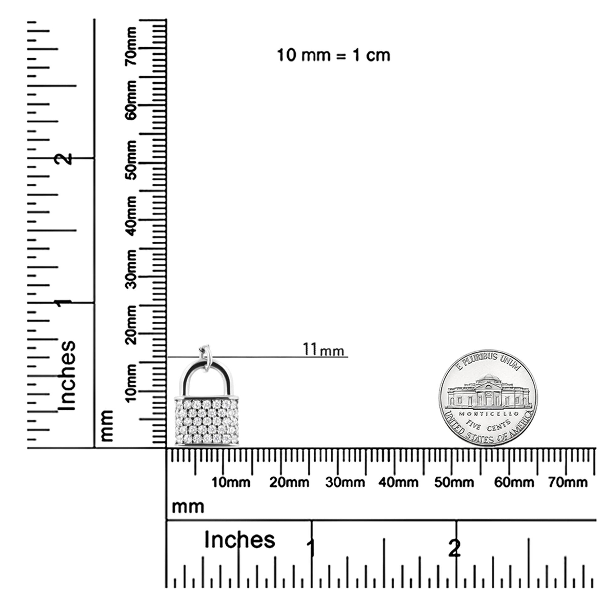 White metal necklace pendant shaped like a padlock with round white gemstones in prong settings, shown on a ruler and scale for size reference, photographed from the front.