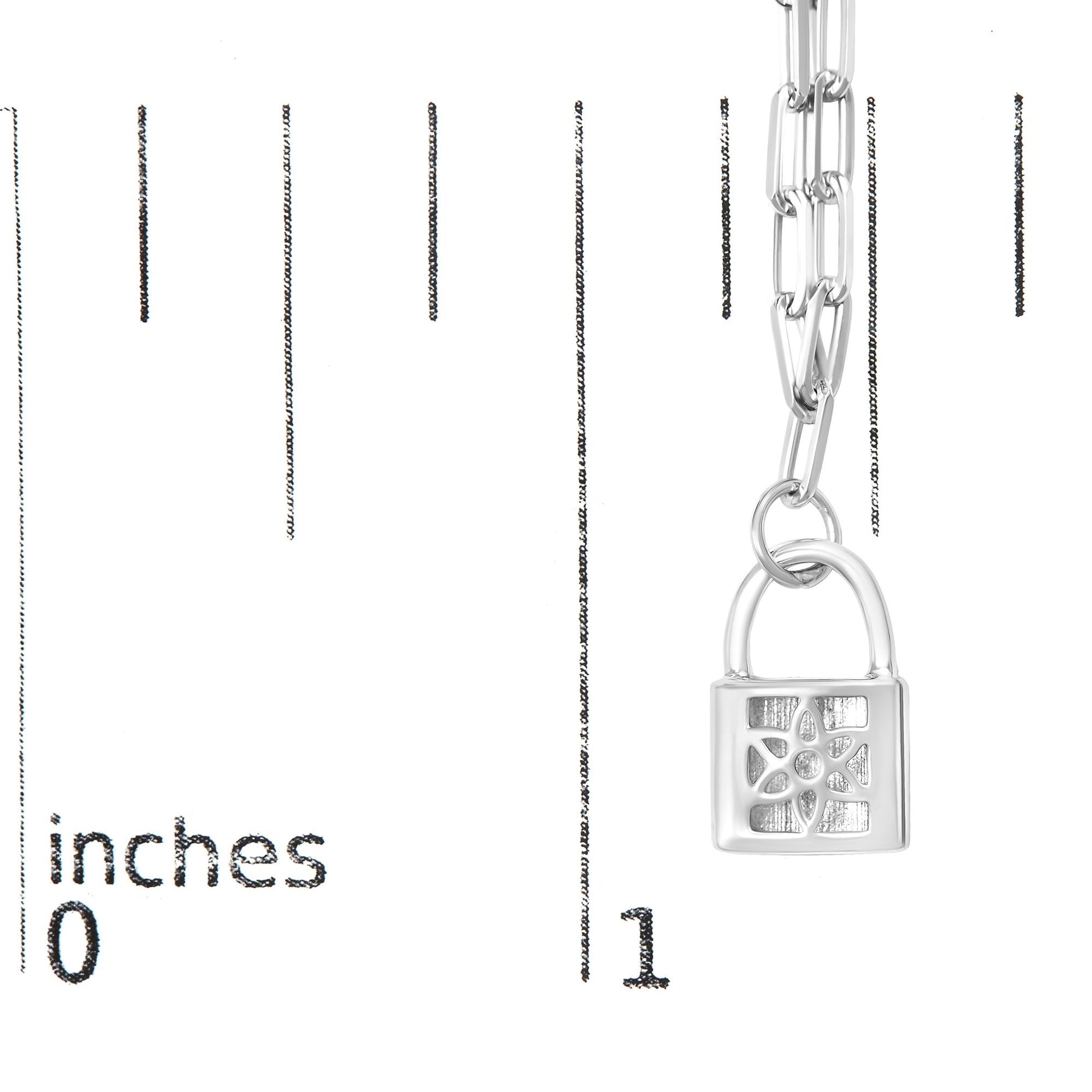 Close-up front angle of a white metal necklace with a padlock pendant featuring a floral design accented with round white gemstones, shown on a ruler for size reference.