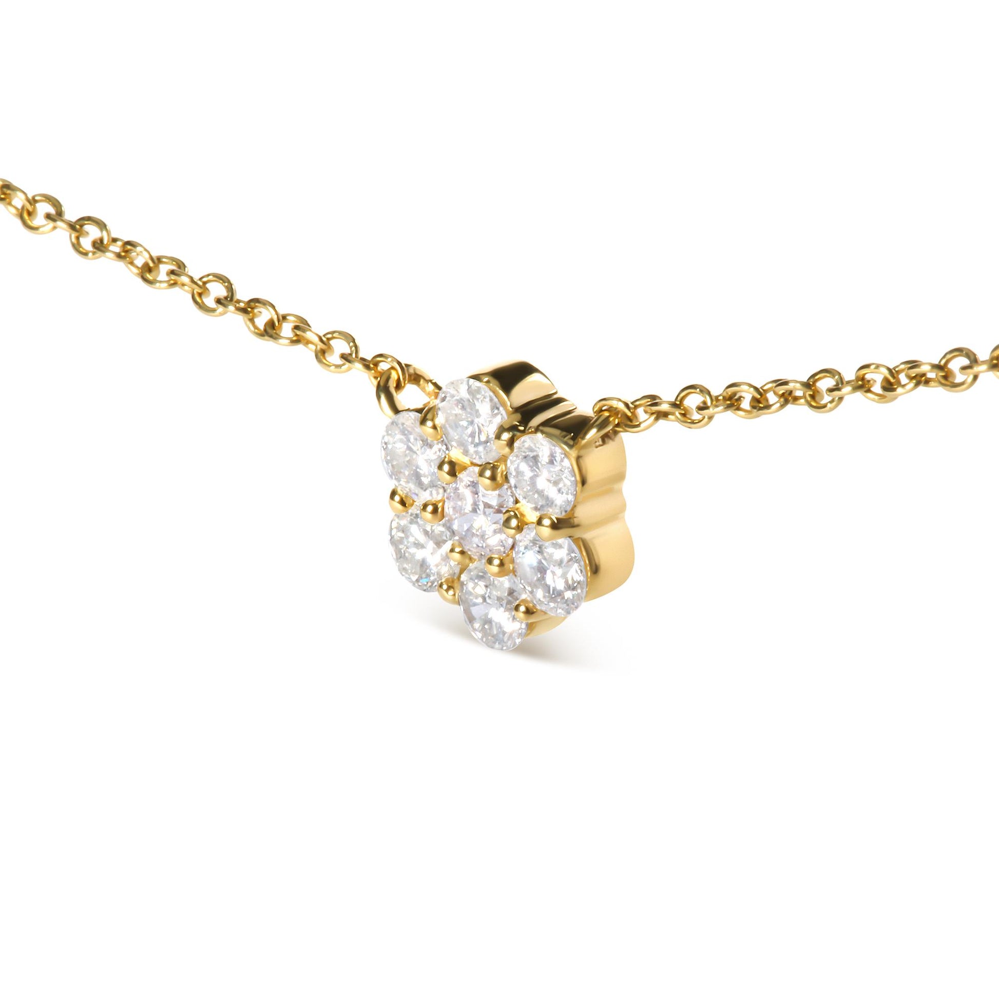 Yellow metal necklace with a flower-shaped pendant featuring round white gemstones, shown in a close-up angled view.