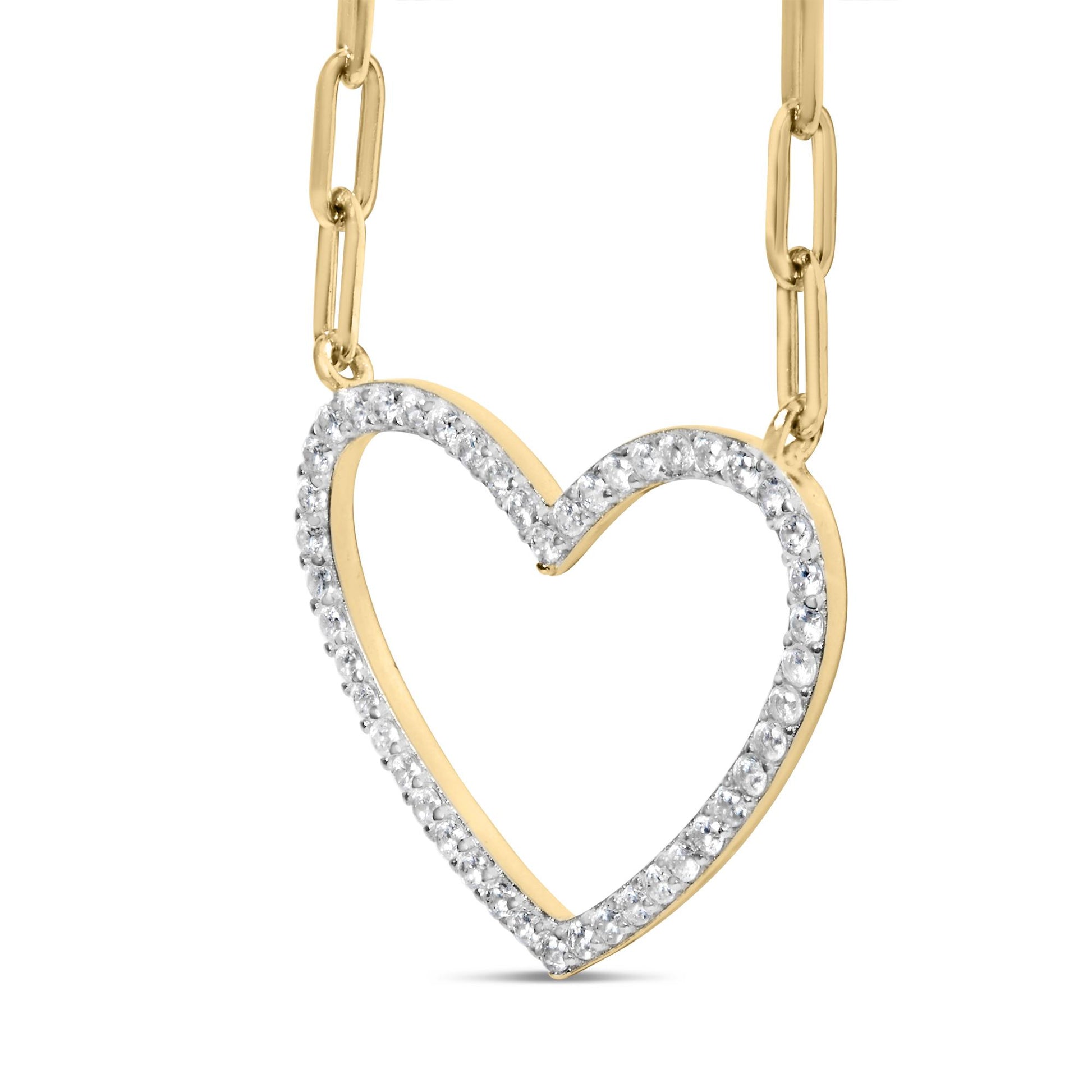 Close-up front angle of a yellow metal heart-shaped necklace pendant with round white gemstones in prong settings along the outline, suspended from a chain.