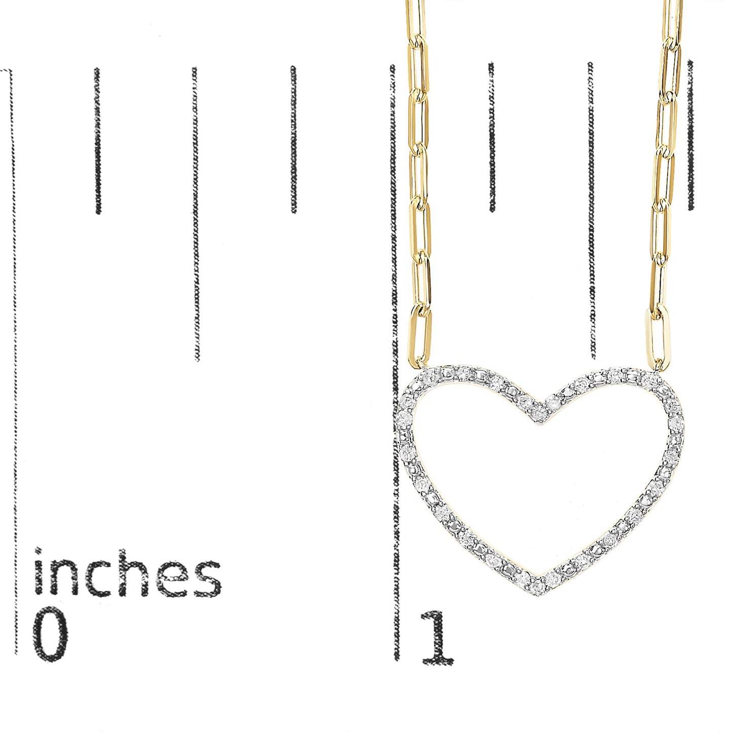 Close-up front view of a yellow metal necklace with a heart-shaped pendant outlined with small white gemstones, shown on a ruler for size reference.