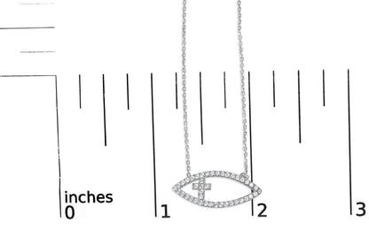White necklace with an eye-shaped pendant encrusted with round white gemstones in prong setting, shown on a ruler for size reference, front-facing angle.