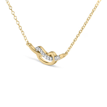 Yellow metal necklace with a twist design accentuated by small white gemstones, shown in a close-up angled view.