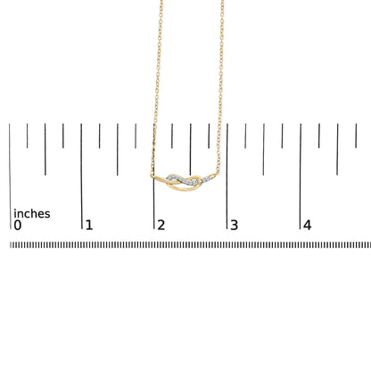Yellow necklace with a curved knot pendant adorned with white round gemstones in prong settings, displayed on a ruler for size reference, front-facing angle.
