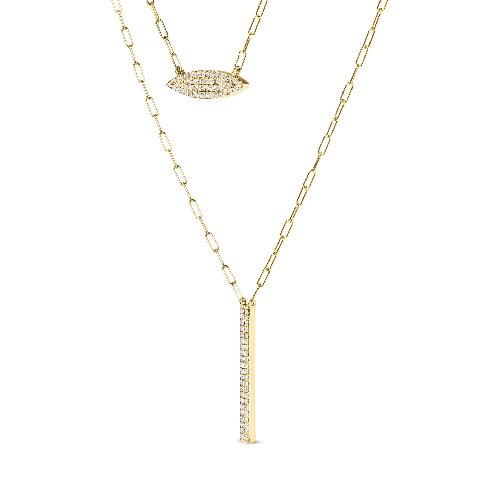 Close-up angled view of a yellow metal necklace with two pendants featuring prong-set white round gemstones, one in an elongated oval shape and the other in a vertical bar shape.
