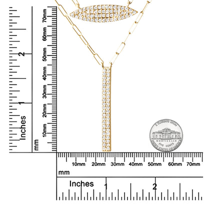 Close-up front view of a yellow metal necklace with two pendants featuring multiple round white gemstones in prong settings, displayed on a ruler and next to a coin for size reference.