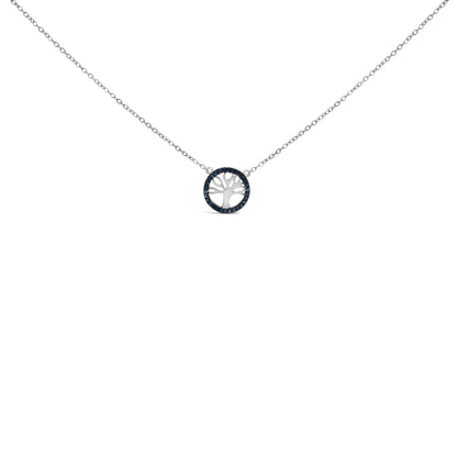 Front-facing shot of a white metal necklace featuring a circular pendant with a tree cutout, surrounded by round blue gemstones in prong settings.