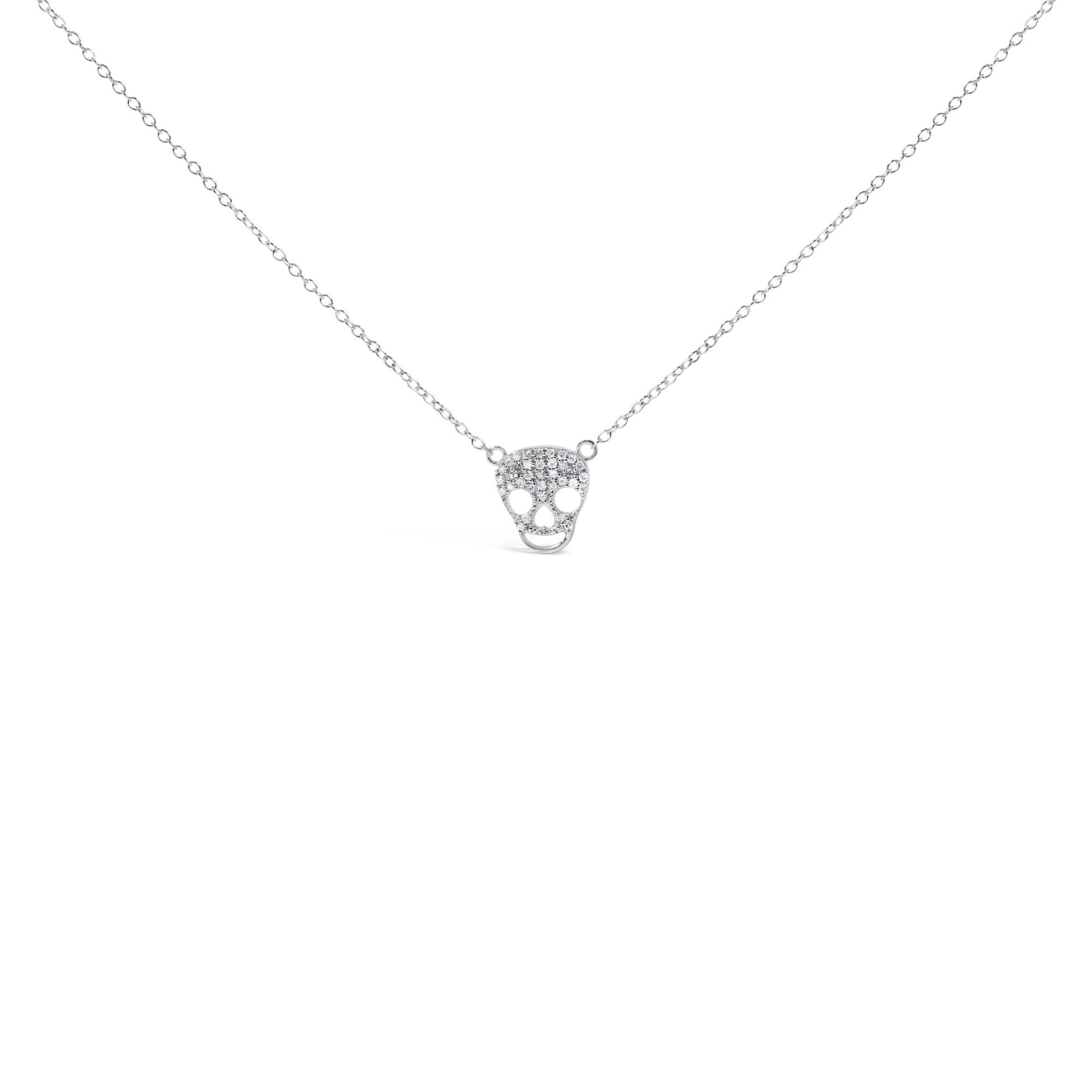 Front view of a white metal necklace with a skull-shaped pendant featuring multiple round white gemstones in a prong setting.