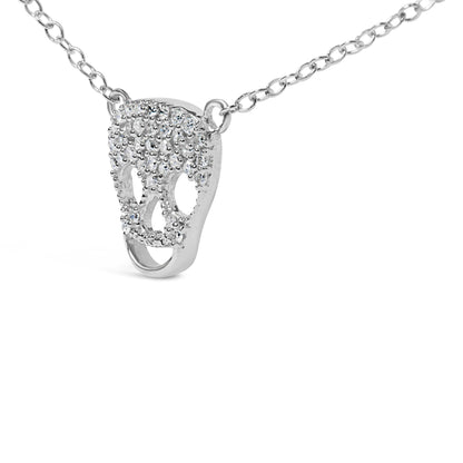 Close-up front angle of a white metal necklace featuring a skull-shaped pendant adorned with round white gemstones in prong settings.