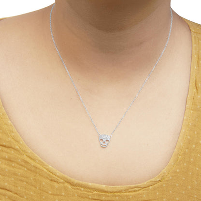 White metal necklace with a skull-shaped pendant adorned with round white gemstones, worn on a model, front-facing angle.