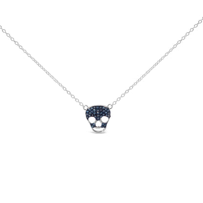 Front angled view of a white metal necklace with a skull-shaped pendant studded with round blue gemstones in a prong setting.