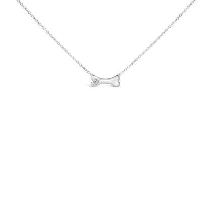 White metal necklace with a bone-shaped pendant featuring a small cluster of round white gemstones in prong settings, front view.