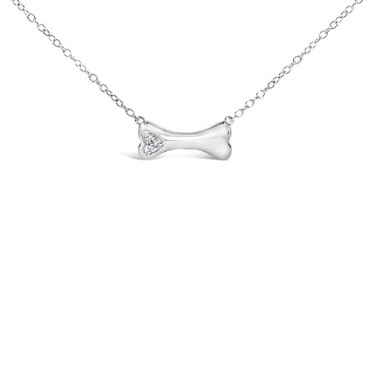 Front view of white metal necklace with a bone-shaped pendant featuring three round white gemstones in prong settings on one end.