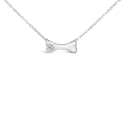 Front view of white metal necklace with a bone-shaped pendant featuring three round white gemstones in prong settings on one end.
