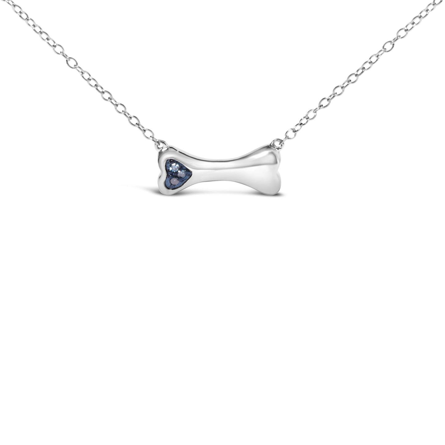 Front-facing shot of a white metal bone-shaped necklace pendant with three round blue gemstones in prong settings on one end.