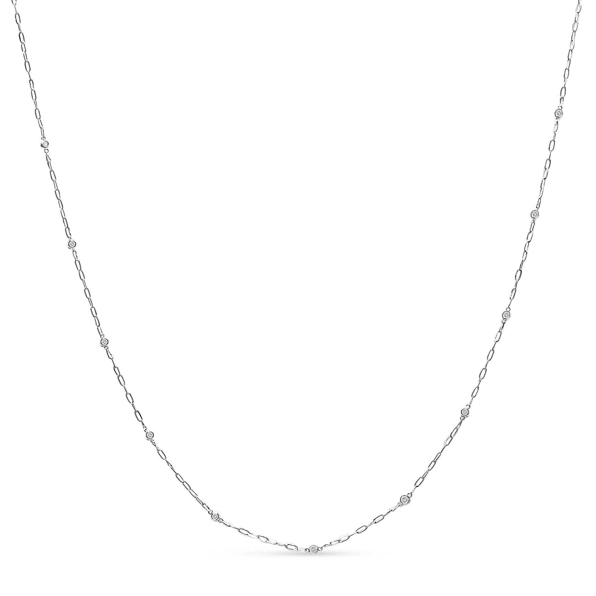 White necklace with a thin chain featuring round white gemstones in bezel settings, shown flat on a white background from the front angle.