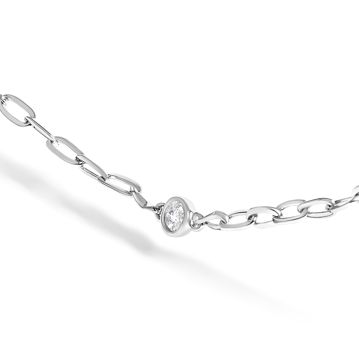 Close-up angle of a white metal necklace chain with a round white gemstone in a bezel setting, shown against a white background.