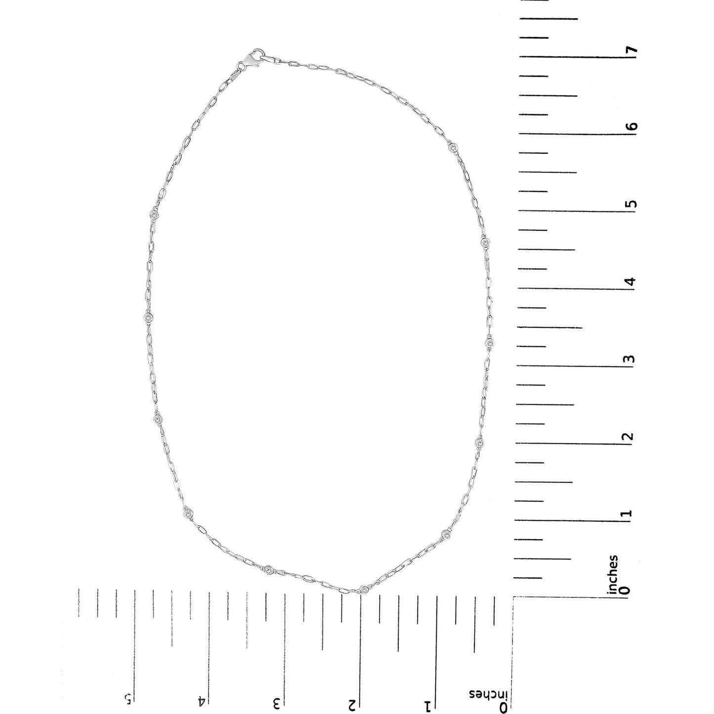 White metal necklace with small round white gemstones in bezel settings evenly spaced along a delicate chain, shown flat on a scale from above.