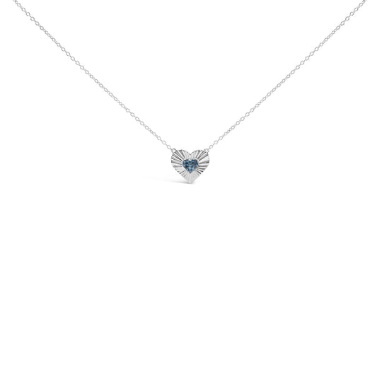 White metal necklace with heart-shaped pendant featuring blue round gemstones in prong setting, shown from front angle.
