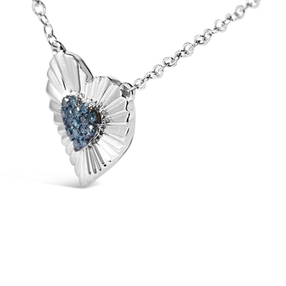 Close-up angled view of a white metal heart-shaped necklace pendant with a cluster of blue round gemstones in prong settings in the center.