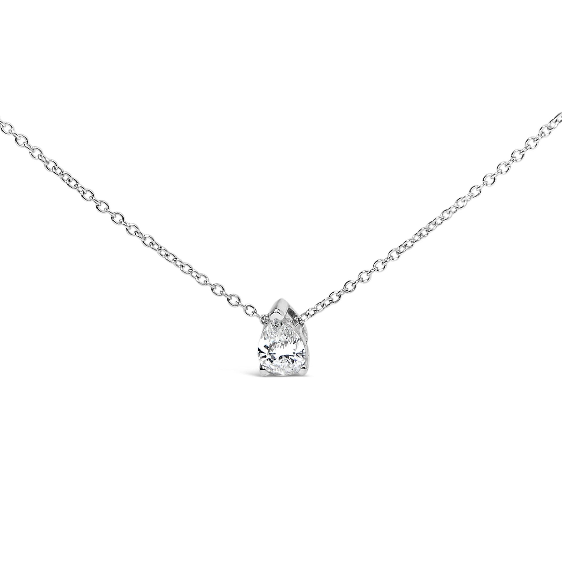 Front angled view of a white metal necklace with a pear-shaped white gemstone in a prong setting.