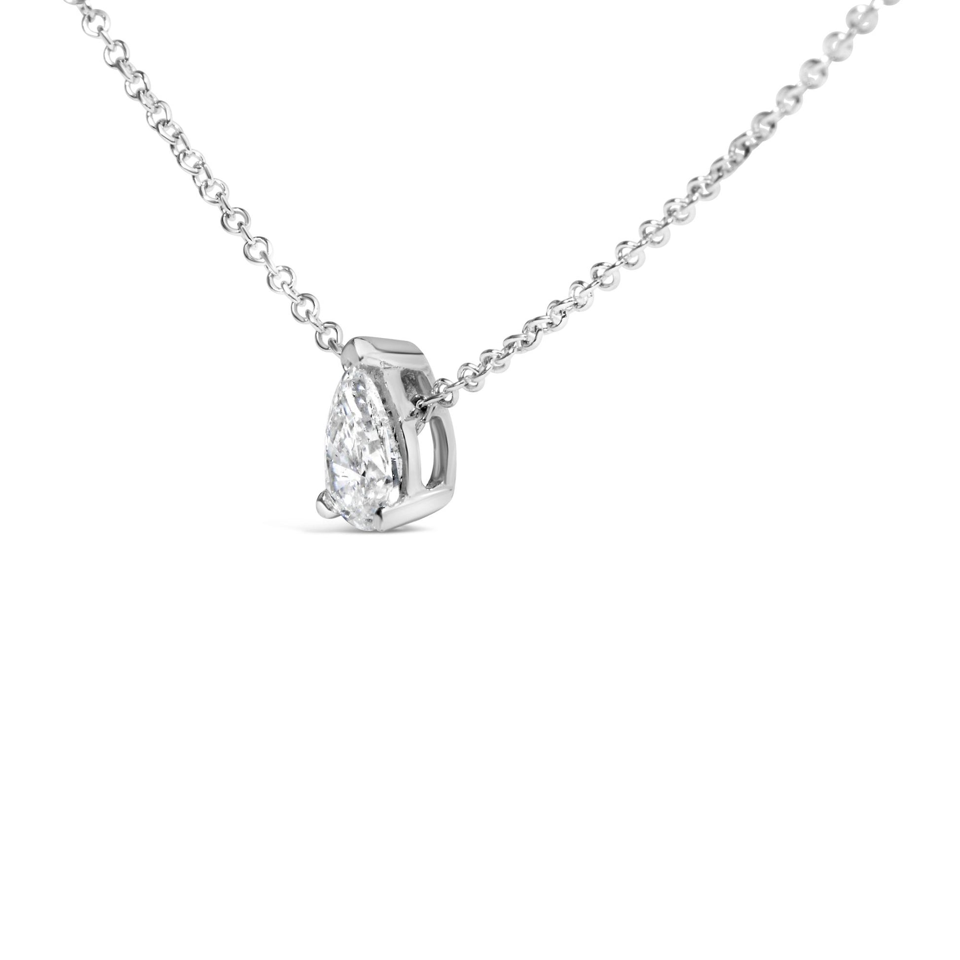 Close-up angled view of a white metal necklace featuring a pear-shaped white gemstone in a prong setting.