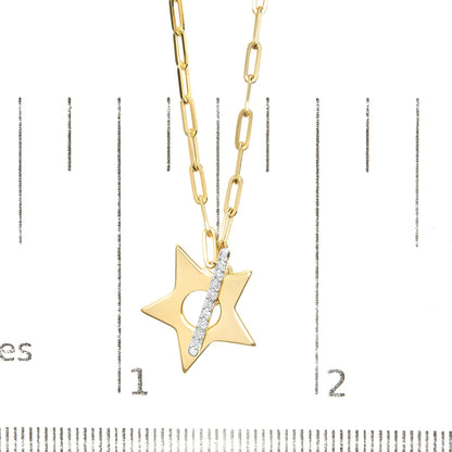 Close-up front view of a yellow metal necklace with a star-shaped pendant featuring a vertical bar set with round white gemstones, shown on a scale.