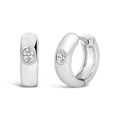 Close-up front angle of white-colored hoop earrings featuring oval-shaped white gemstones set in bezel settings.