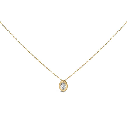 Close-up front view of a yellow metal necklace with an oval white gemstone in a bezel setting as the pendant.