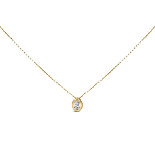 Close-up front view of a yellow metal necklace with an oval white gemstone in a bezel setting as the pendant.