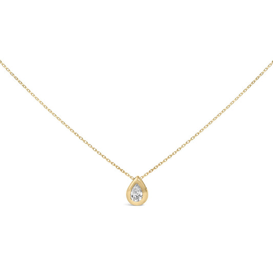 Close-up front angle of a yellow metal necklace with a single pear-shaped white gemstone in a bezel setting.