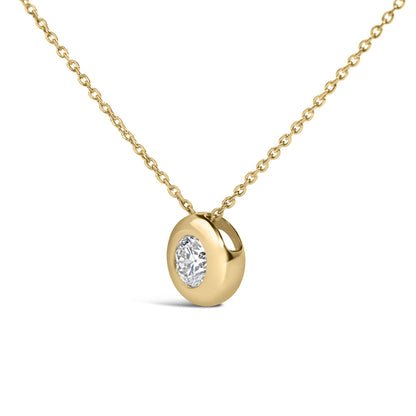 Close-up front angle of a yellow metal necklace with a round white gemstone in a bezel setting on a chain, shown on a white background.