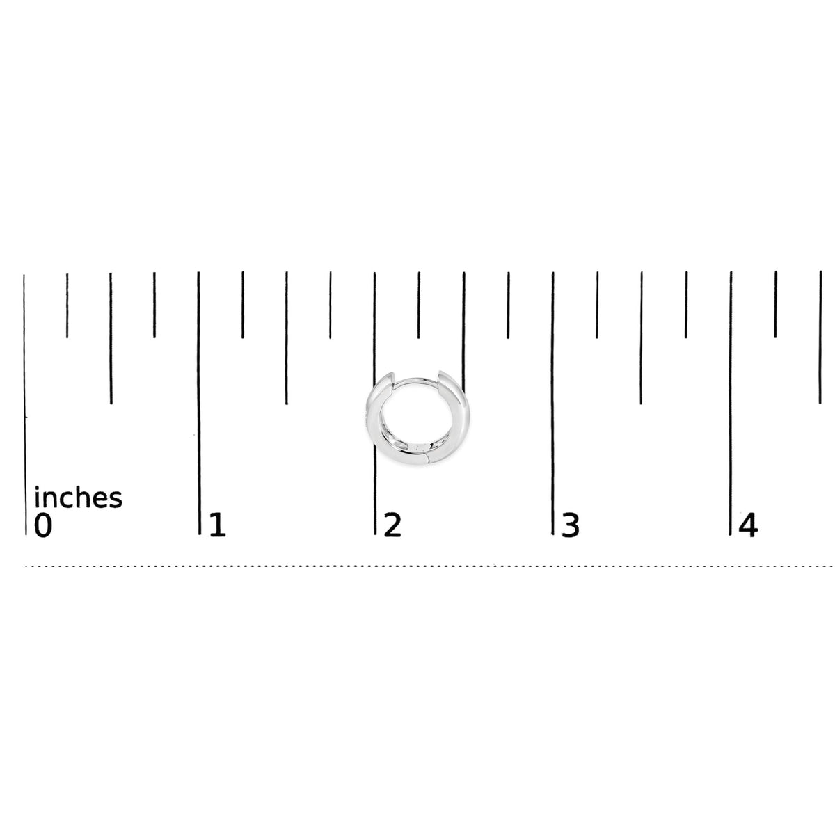 Front view of 14K white gold pear diamond bezel set huggie earrings against an inch measurement scale