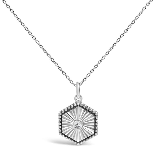 Front view of 10K white gold hexagon fluted medallion pendant necklace with diamond accents on white background