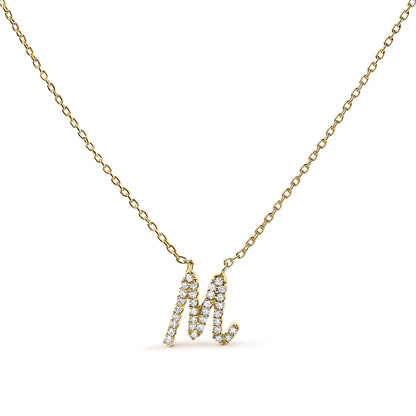 Front-facing shot of a yellow metal necklace with a pendant in the shape of the letter M, adorned with small white gemstones in a micro-pave setting.