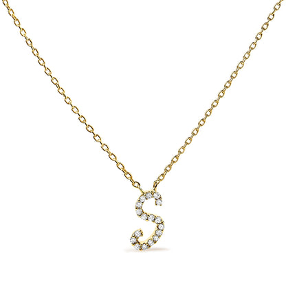 Yellow metal necklace with a pendant shaped like the letter S, adorned with round white gemstones in a micro-pave setting, photographed from the front on a white background.