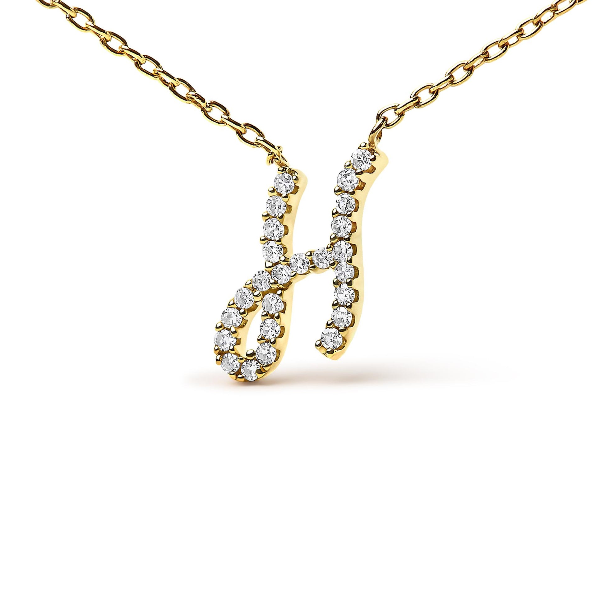 Close-up front view of a yellow metal necklace pendant shaped like the letter H, adorned with round white gemstones in a micro-pave setting, shown on a white background.