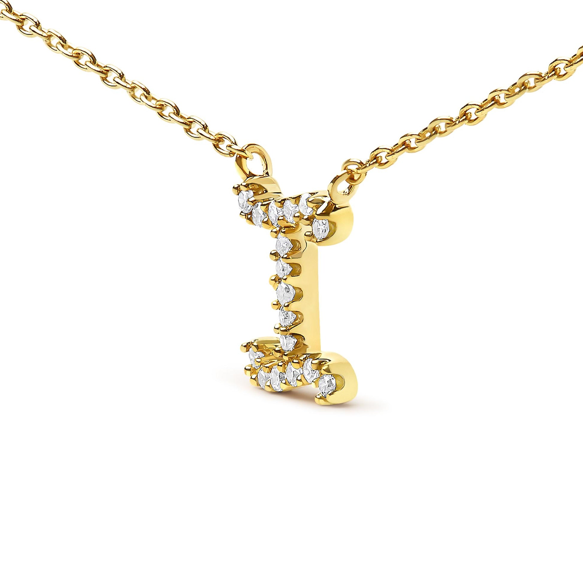 Close-up front angle of a yellow metal necklace pendant in the shape of the letter 'I' adorned with small white round gemstones in a micro-pave setting.