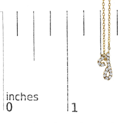 Close-up of a yellow necklace pendant with two script letter charms adorned with round white gemstones in a micro-pave setting, shown on a vertical scale.