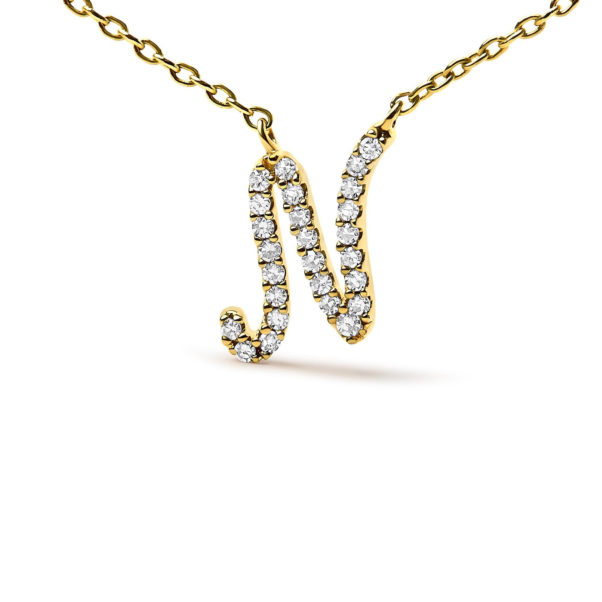 Close-up front view of a yellow necklace with a pendant in the shape of the letter 'N,' adorned with white round gemstones in a micro-pave setting.