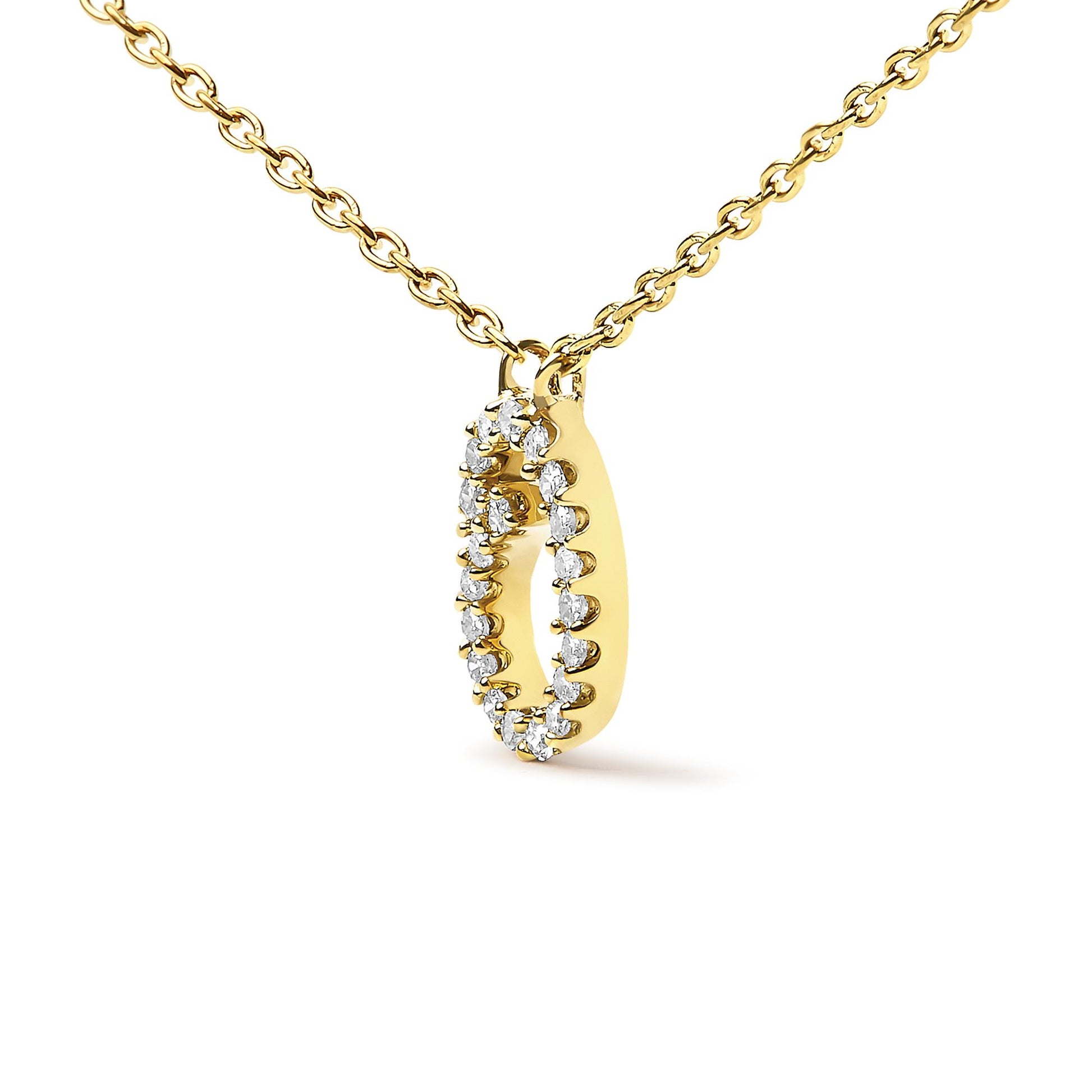 Close-up front angle of a yellow metal necklace with an oval-shaped pendant featuring a micro-pave setting of round white gemstones around its perimeter.